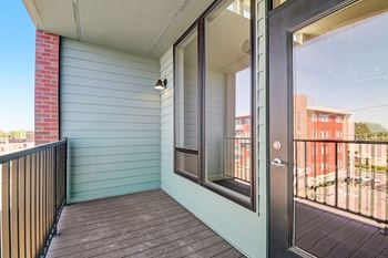 a balcony with a door that leads to a balcony